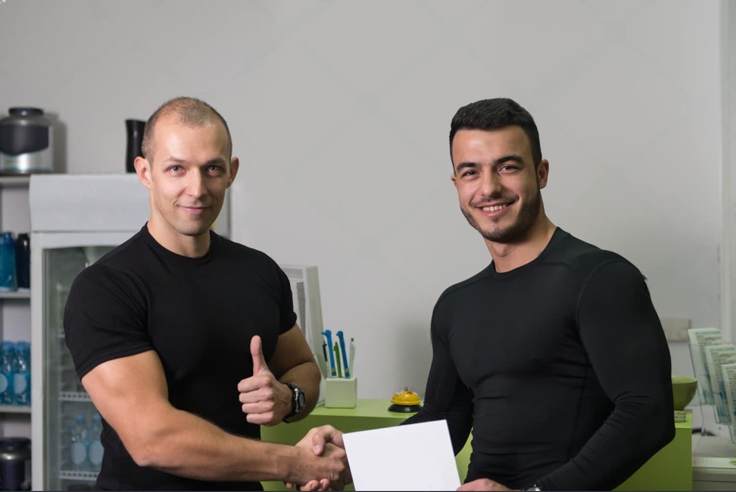 Gym Instructor and Student with personal trainer certificate